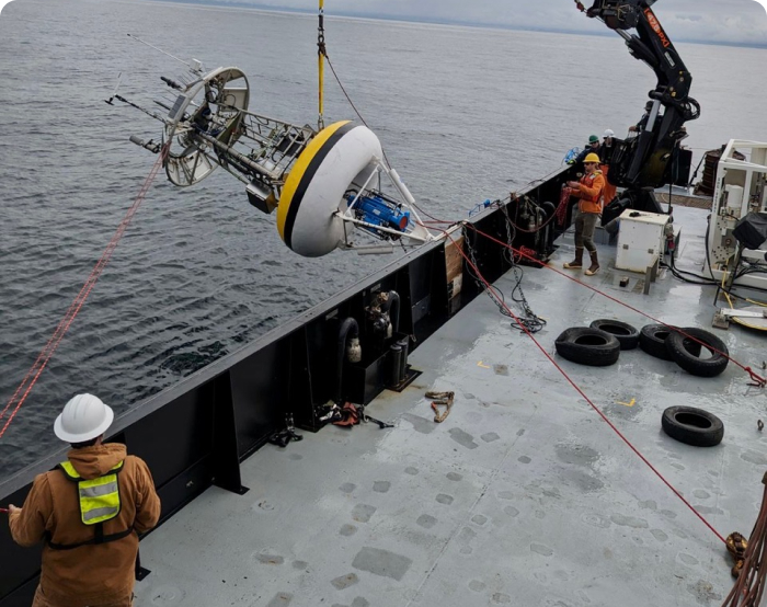 Robot being loaded into water off ship